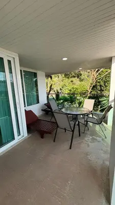 a patio with a table and chairs on a porch at 3 Beds patong baycleef residence in Patong Beach