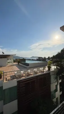 a balcony of a building with chairs and a swimming pool at 3 Beds patong baycleef residence in Patong Beach