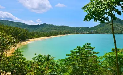 a view of a beach with mountains in the background at PapaCrab Boutique Guesthouse in Kamala Beach