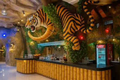 a large tiger statue above a bar in a restaurant at Tiger Complex Inn in Patong Beach