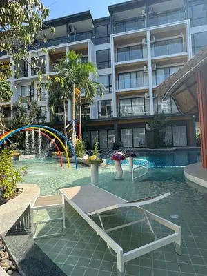 a swimming pool with a playground in a building at Apartment Wyndham Naithon in Nai Thon Beach