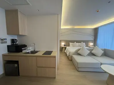 a kitchen and a bedroom with a bed and a couch at Apartment Wyndham Naithon in Nai Thon Beach