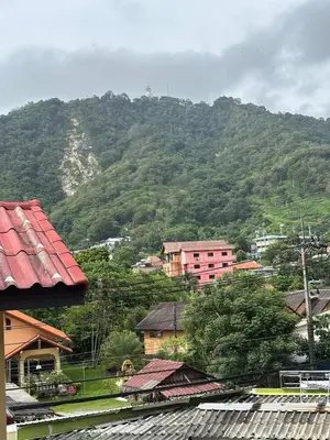 a city with a mountain in the background at Milos House in Phuket Town