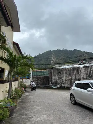 a car parked in a parking lot next to a building at Milos House in Phuket Town