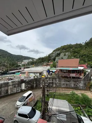 a group of cars parked in a parking lot at Milos House in Phuket Town