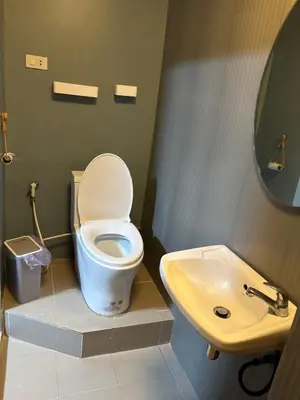 a bathroom with a toilet and a sink at Milos House in Phuket Town