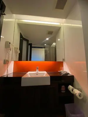 a bathroom with a sink and a mirror at The Beach Condotel Kata in Kata Beach