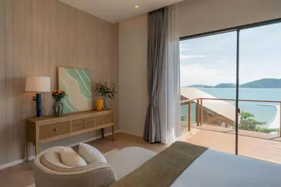 a bedroom with a bed and a view of the ocean at Villa Belle Air Panwa Beachfront 6BR Breakfast included in Ban Ao Makham