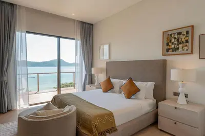 a bedroom with a large bed and a large window at Villa Belle Air Panwa Beachfront 6BR Breakfast included in Ban Ao Makham