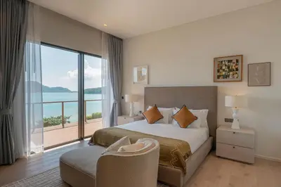 a bedroom with a large bed and a large window at Villa Belle Air Panwa Beachfront 6BR Breakfast included in Ban Ao Makham