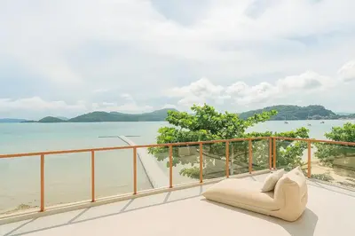 a balcony with a view of the water at Villa Belle Air Panwa Beachfront 6BR Breakfast included in Ban Ao Makham