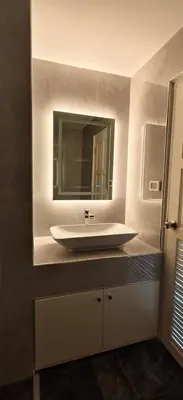 a bathroom with a white sink and a mirror at patong sea view-high floor in Patong Beach