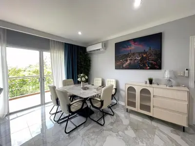 a dining room with a table and chairs at Green place condominium in Ban Lo Long