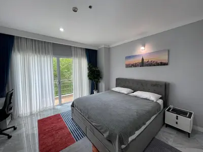 a bedroom with a bed and a large window at Green place condominium in Ban Lo Long