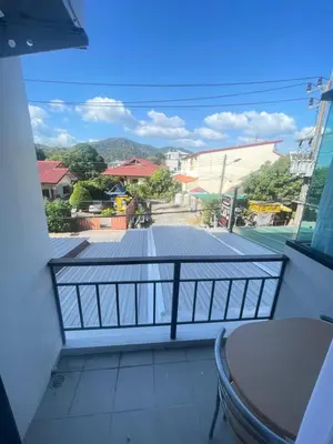 a balcony with a view of a street at Nai-harn Apartments in Phuket Town