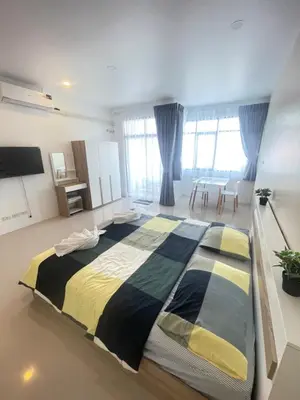 a bedroom with a large bed in a room at Nai-harn Apartments in Phuket Town