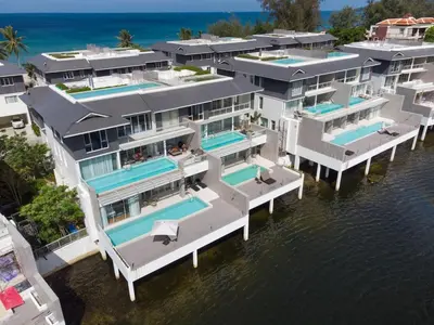 an aerial view of a house on the water at Beachfront residence - just a step from the beach in Laguna Phuket