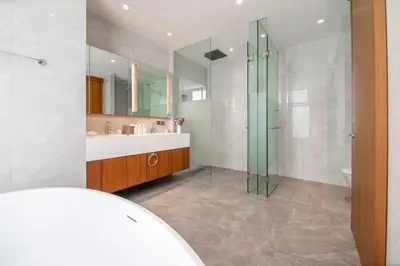 a bathroom with a glass shower and a sink at Beachfront residence - just a step from the beach in Laguna Phuket