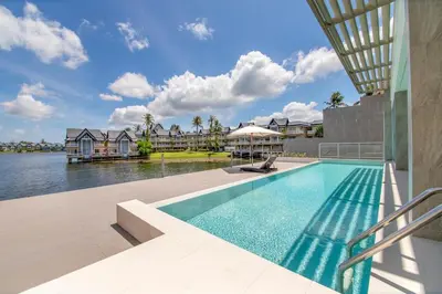 a swimming pool with a view of the water at Beachfront residence - just a step from the beach in Laguna Phuket