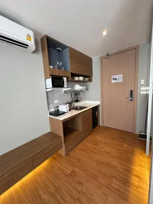 a small kitchen with a sink and a microwave at Apartment Naithon Wyndham in Nai Thon Beach