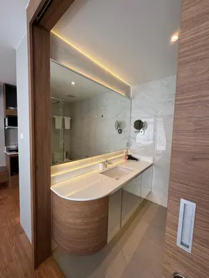 a bathroom with a sink and a large mirror at Apartment Naithon Wyndham in Nai Thon Beach