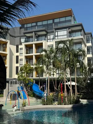 a hotel with a playground in front of a building at Apartment Naithon Wyndham in Nai Thon Beach