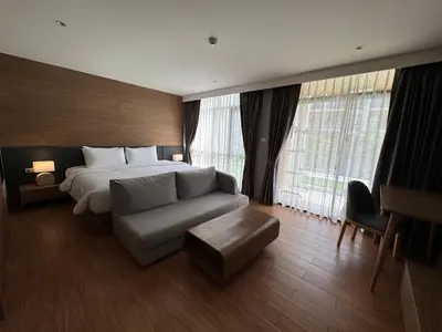 a hotel room with a bed and a couch at Apartment Naithon Wyndham in Nai Thon Beach