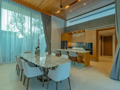 an open kitchen and dining room with a marble table and chairs at Luxury 4BR Pool Villa in Botanica - Villa Boa in Ban Phru Champa