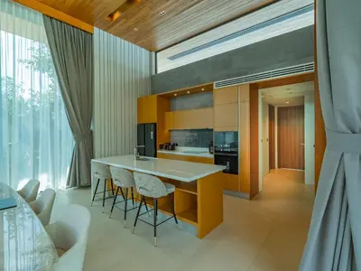a kitchen with a large island with bar stools at Luxury 4BR Pool Villa in Botanica - Villa Boa in Ban Phru Champa