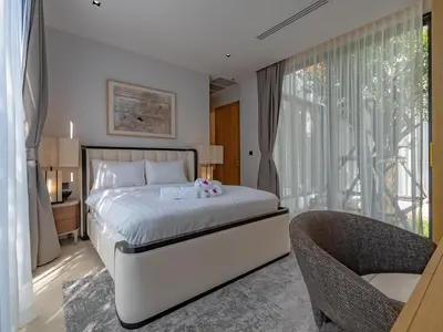 a bedroom with a bed and a chair and a window at Luxury 4BR Pool Villa in Botanica - Villa Boa in Ban Phru Champa