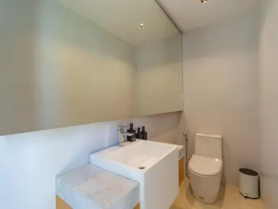 a bathroom with a white sink and a toilet at Luxury 4BR Pool Villa in Botanica - Villa Boa in Ban Phru Champa