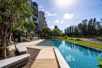 a swimming pool in front of a building at 1Bdr in Cassia Residence Laguna in Laguna Phuket
