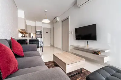 a living room with a couch and a flat screen tv at 1Bdr in Cassia Residence Laguna in Laguna Phuket