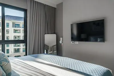 a bedroom with a bed and a large window at The Title Legendary White Reef 2BR in Bang Tao Beach
