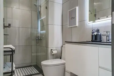 a bathroom with a toilet and a glass shower at The Title Legendary White Reef 2BR in Bang Tao Beach