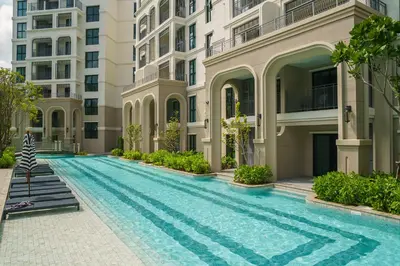 a swimming pool in front of a building at The Title Legendary White Reef 2BR in Bang Tao Beach