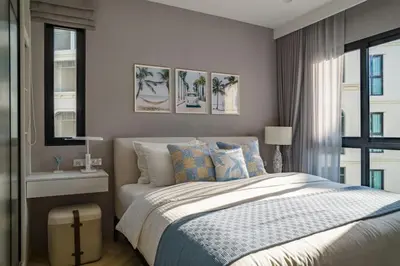 a bedroom with a bed and a window at The Title Legendary White Reef 2BR in Bang Tao Beach