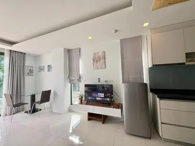 a kitchen with a table and chairs in a room at Modern 1 Bedroom Apartment - At The Tree Rawai in Rawai Beach