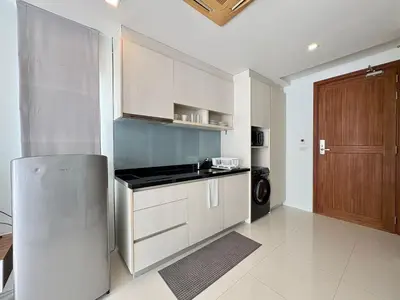 a kitchen with a stainless steel refrigerator and a stove at Modern 1 Bedroom Apartment - At The Tree Rawai in Rawai Beach