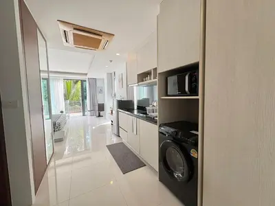 a kitchen with a washer and dryer in a room at Modern 1 Bedroom Apartment - At The Tree Rawai in Rawai Beach