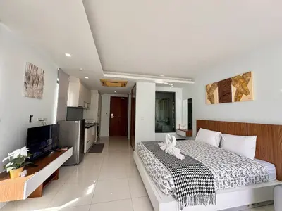 a bedroom with a bed and a television in it at Modern 1 Bedroom Apartment - At The Tree Rawai in Rawai Beach