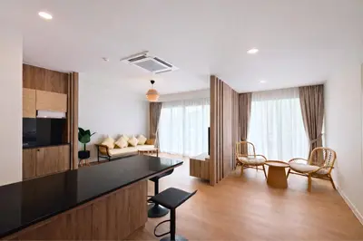 a living room with a dining room at Aqua Maya Phuket in Patong Beach
