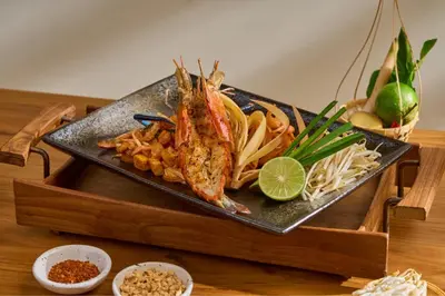 a plate of food with seafood on a table at Aqua Maya Phuket in Patong Beach