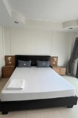 a bedroom with a large white bed in a room at Smile room 21 in Patong Beach