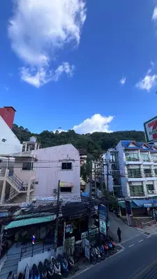 a group of buildings with motorcycles parked on a street at Smile room 21 in Patong Beach