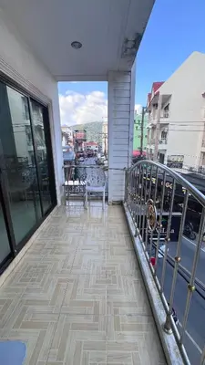 a balcony with a table and chairs on a building at Smile room 21 in Patong Beach