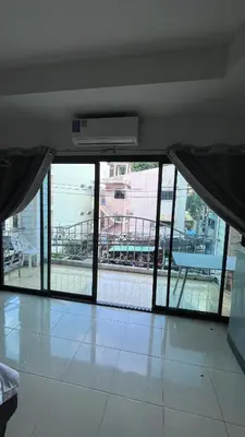 an empty room with sliding glass doors and a balcony at Smile room 21 in Patong Beach