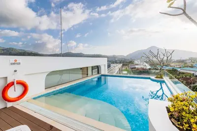 a swimming pool on the roof of a house at C256 2BR Stay Close to Beach Rooftop Pool Views in Kamala Beach