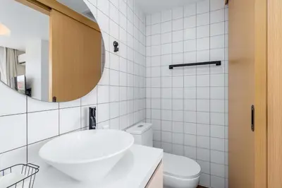a white bathroom with a sink and a mirror at C256 2BR Stay Close to Beach Rooftop Pool Views in Kamala Beach