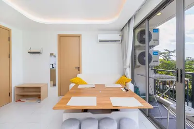 a dining room with a table and a balcony at C256 2BR Stay Close to Beach Rooftop Pool Views in Kamala Beach